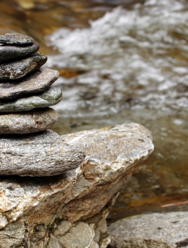 Rocks stacked together by a water body