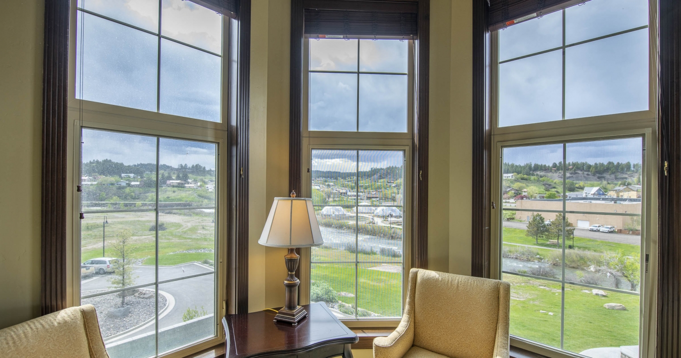 The bedroom sitting area next to the windows