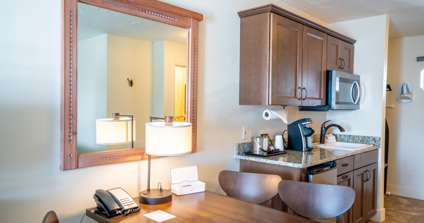 Wooden table next to the kitchen area