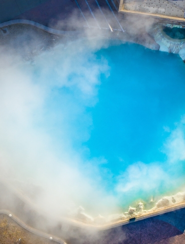 Aerial view of the steam rising from the hot spring pool