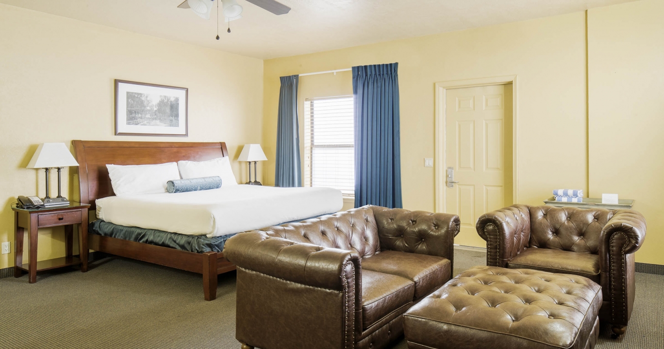 The bed behind the sofas and the ottoman in the Quien Sabe room