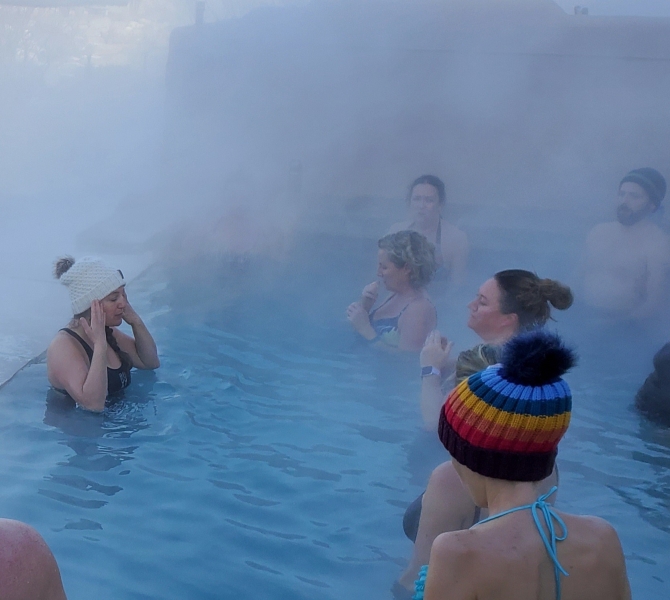 A group practicing water yoga in the hot spring pool